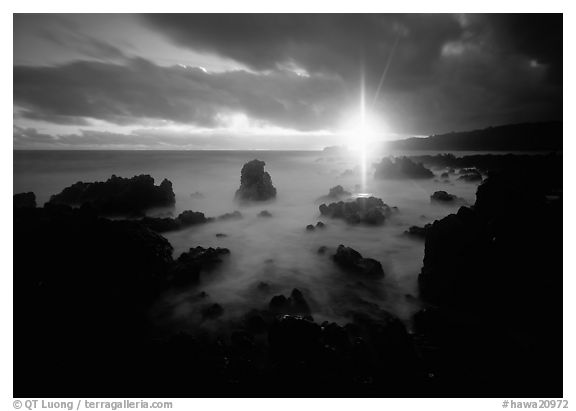 Sun shining brilliantly over primeval seascape, Kenae Peninsula. Hawaii, USA (black and white)