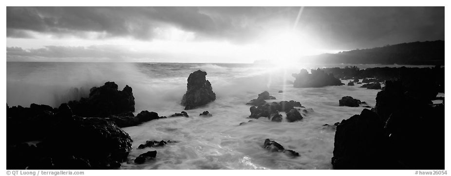 Primeval seascape with surf and rising sun. Maui, Hawaii, USA (black and white)
