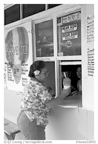 Woman with a flower in hair getting shave ice, Waimanalo. Oahu island, Hawaii, USA (black and white)