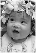 Baby girl wearing a flower lei on her head. Waikiki, Honolulu, Oahu island, Hawaii, USA ( black and white)