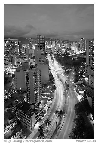 Boulevard and high rise buildings at dusk. Waikiki, Honolulu, Oahu island, Hawaii, USA (black and white)