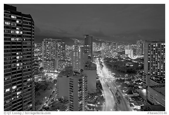 Boulevard and high-rise towers at dusk. Waikiki, Honolulu, Oahu island, Hawaii, USA (black and white)