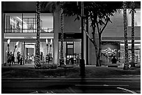 Shopping section of Kalakaua avenue at night. Waikiki, Honolulu, Oahu island, Hawaii, USA ( black and white)