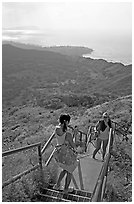 Tourists take a photo on the last steps of the Diamond Head crater summit trail. Oahu island, Hawaii, USA (black and white)