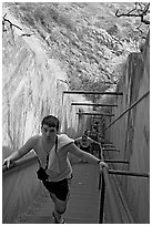 Tourist climbing a staircase on the Diamond Head summit trail. Oahu island, Hawaii, USA (black and white)