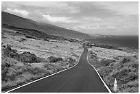 Road across arid landscape. Maui, Hawaii, USA (black and white)