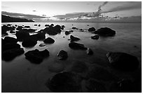 Boulders in water near Kalihika Park, sunset. Kauai island, Hawaii, USA ( black and white)