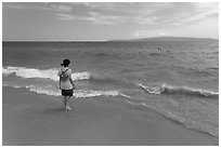 Girl stepping into water, Big Beach. Maui, Hawaii, USA ( black and white)