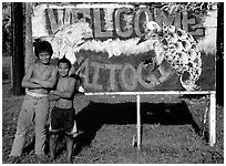 Children in front of a turtle a shark sign in Vaitogi. Tutuila, American Samoa (black and white)