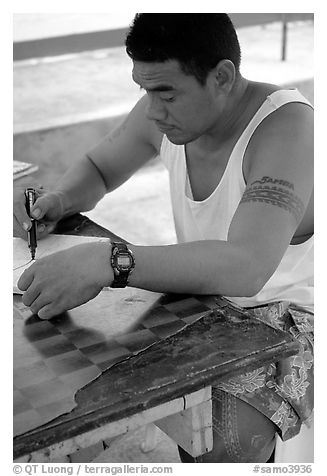 Young man drawing an artwork based on traditional siapo designs. Pago Pago, Tutuila, American Samoa (black and white)