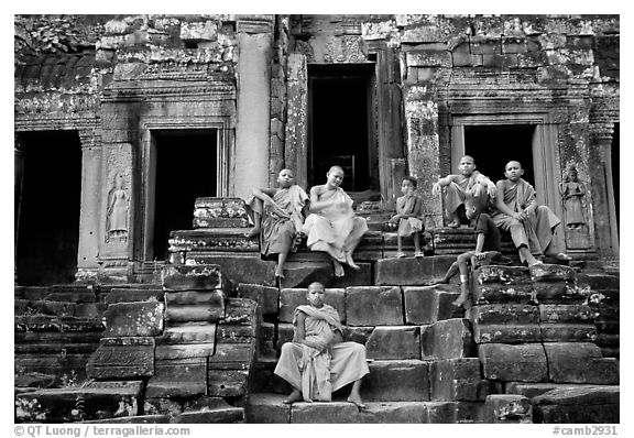 Buddhist monks sitting on steps, Angkor Wat. Angkor, Cambodia (black and white)