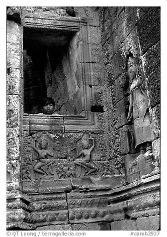 Boy hides in the Bayon. Angkor, Cambodia (black and white)
