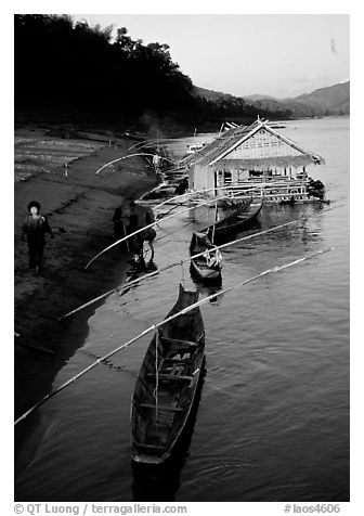 Boats and stilt house of a small hamlet. Mekong river, Laos
