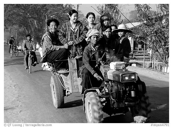 Riding tractor on road near Swwenyaung. Shan state, Myanmar (black and white)