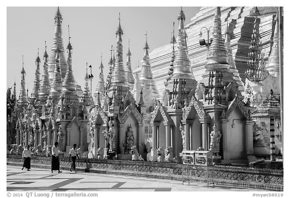 Men walking near stupas, Shwedagon Pagoda. Yangon, Myanmar (black and white)