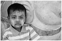 Child with thanaka paste next to elephant. Yangon, Myanmar ( black and white)