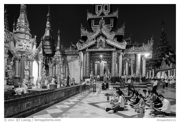 Praying on the platform at night. Yangon, Myanmar (black and white)