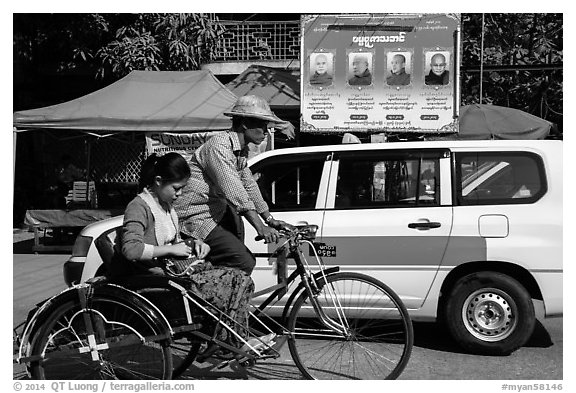 Trishaw, taxi, and billboard promoting monks. Yangon, Myanmar (black and white)