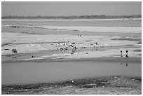 Sandy banks of Ayeyarwaddy River with villagers washing clothes. Bagan, Myanmar ( black and white)