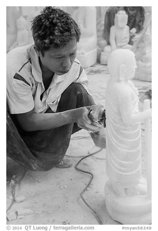 Stone sculptor finishing buddha statue. Mandalay, Myanmar (black and white)