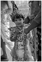Young girl dressed in glittering attire during novitiation, Mahamuni Pagoda. Mandalay, Myanmar ( black and white)