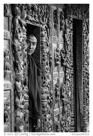Monk pearing from window, Shwe In Bin Kyaung pagoda. Mandalay, Myanmar (black and white)