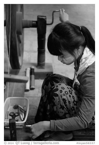 Woman assembling a yarn package. Amarapura, Myanmar (black and white)