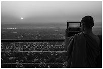 Monk taking picture of sunset from Sagaing Hill. Myanmar ( black and white)