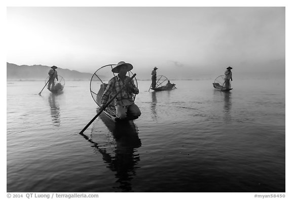 Group of Intha fishermen at dawn with surface mist. Inle Lake, Myanmar (black and white)