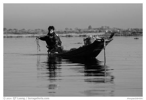 Fisherman retrieves net. Inle Lake, Myanmar (black and white)