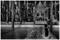 Woman praying at Nga Phe Kyaung monastery. Inle Lake, Myanmar ( black and white)