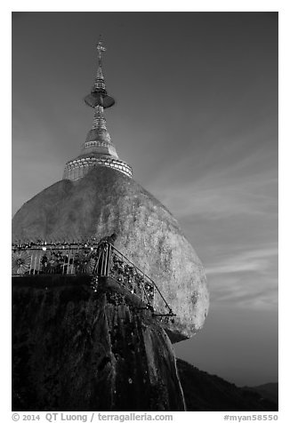 Monk standing on Golden Rock looks into the valley. Kyaiktiyo, Myanmar (black and white)