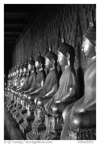 Row of Buddha statues in gallery, Wat Arun. Bangkok, Thailand (black and white)
