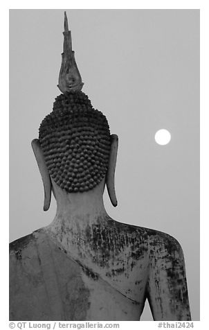Moon and buddha image at dusk, Wat Mahathat. Sukothai, Thailand