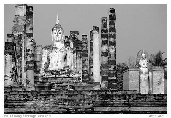 Columns and Buddha statue, Wat Mahathat. Sukothai, Thailand (black and white)