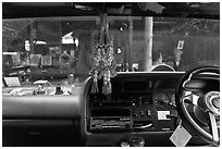 Bus dashboard with religious items. Thailand (black and white)