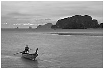 Man driving long tail boat, Ao Nammao. Krabi Province, Thailand (black and white)