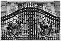 Entrance grids of Buckingham Palace with royalty emblems. London, England, United Kingdom ( black and white)