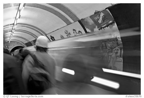 People and train in motion, London underground. London, England, United Kingdom (black and white)