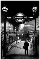 Man entering underground, and motion-blurred double decker bus,  Piccadilly Circus. London, England, United Kingdom ( black and white)
