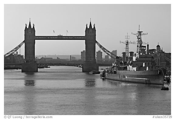 London Bridge, River Thames, and cruiser HMS Belfast at sunrise. London, England, United Kingdom (black and white)
