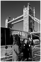Passengers disembarking a boat in their morning commute, Tower Bridge in the background. London, England, United Kingdom ( black and white)