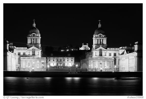 Old Royal Naval College, Queen's house, and Royal observatory with laser marking the Prime meridian at night. Greenwich, London, England, United Kingdom (black and white)