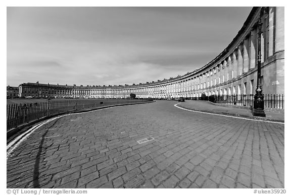 Cobblestone pavement and curved facade of Royal Crescent. Bath, Somerset, England, United Kingdom (black and white)