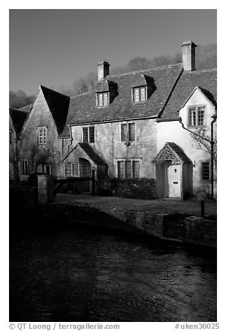 Cotswold type cottages and Bybrook River, Castle Combe. Wiltshire, England, United Kingdom