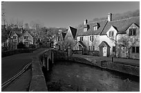 Main village street and Bybrook River, late afternoon, Castle Combe. Wiltshire, England, United Kingdom (black and white)
