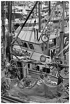 Man and woman repairing nets on fishing boat. Whittier, Alaska, USA (black and white)