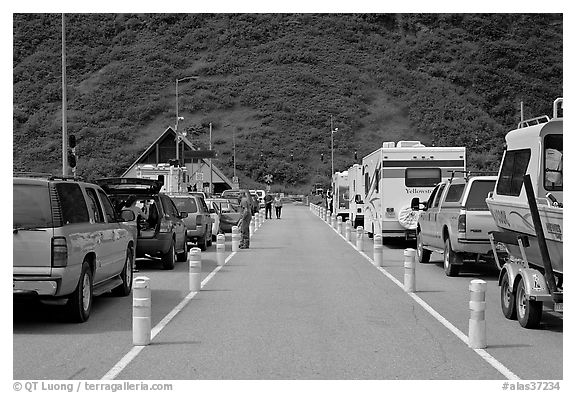 Cars and RVs lining up for the tunnel crossing. Whittier, Alaska, USA (black and white)