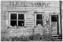 Windows and doors of old hardware store. McCarthy, Alaska, USA (black and white)