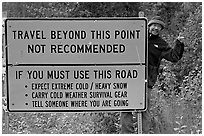 Sign with warnings about winter travel, Exit Glacier Road. Seward, Alaska, USA ( black and white)